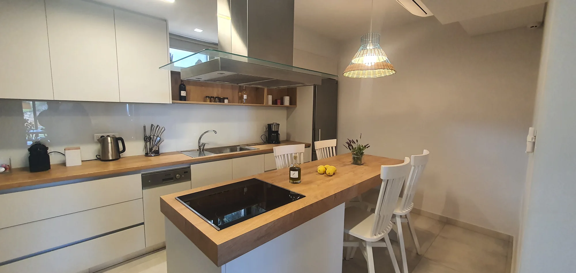 Open-plan kitchen and oak dining table at Villa Erato, Physis Villas Chania