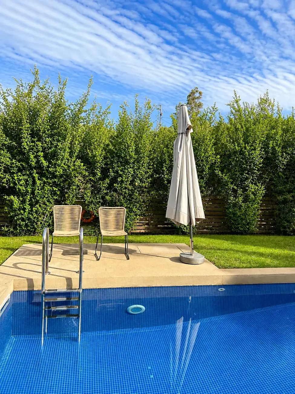 Poolside seating with parasol at Villa Erato, Physis Villas Chania